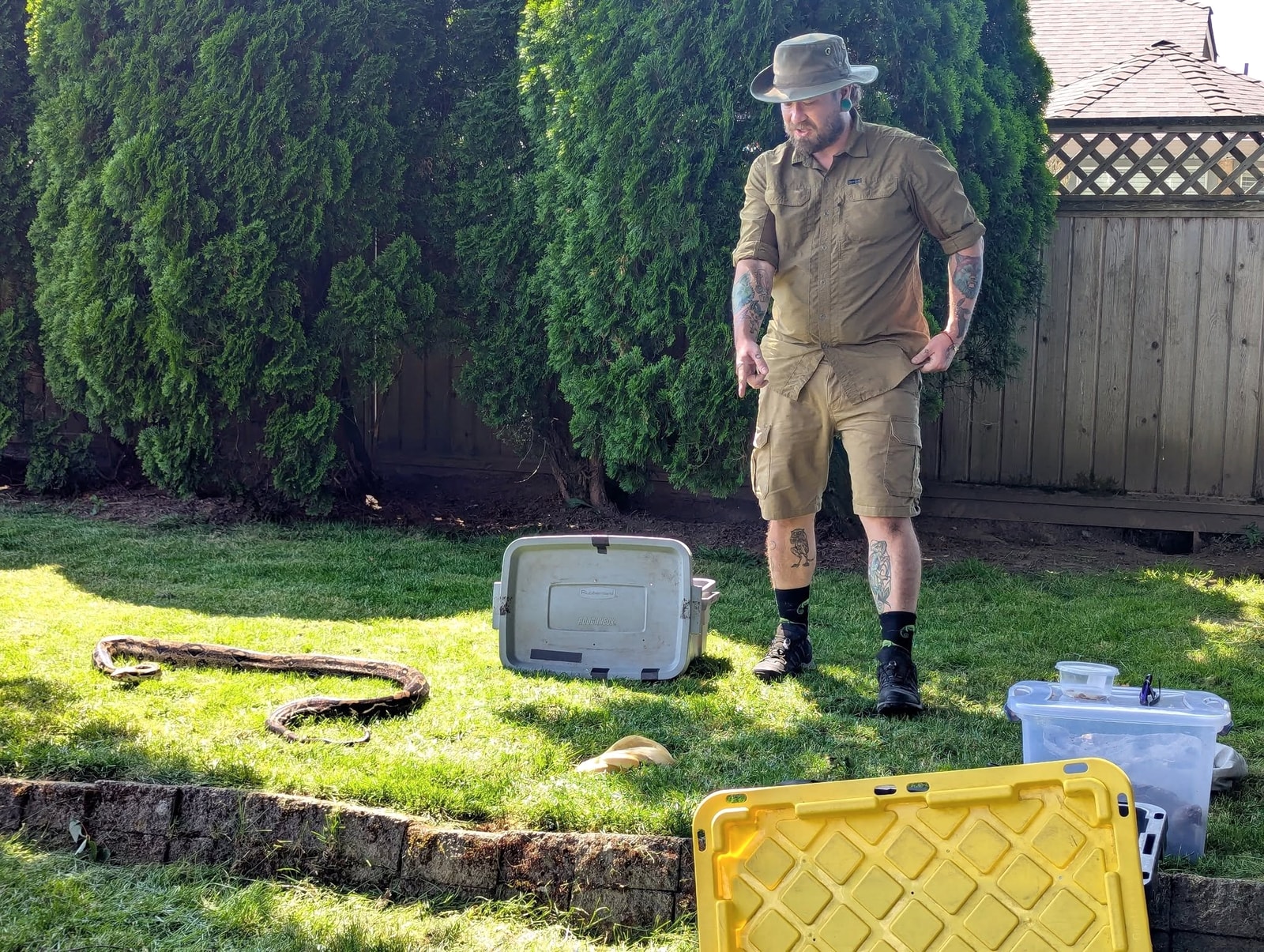 Kevin presenting beside two snakes during an outdoor event