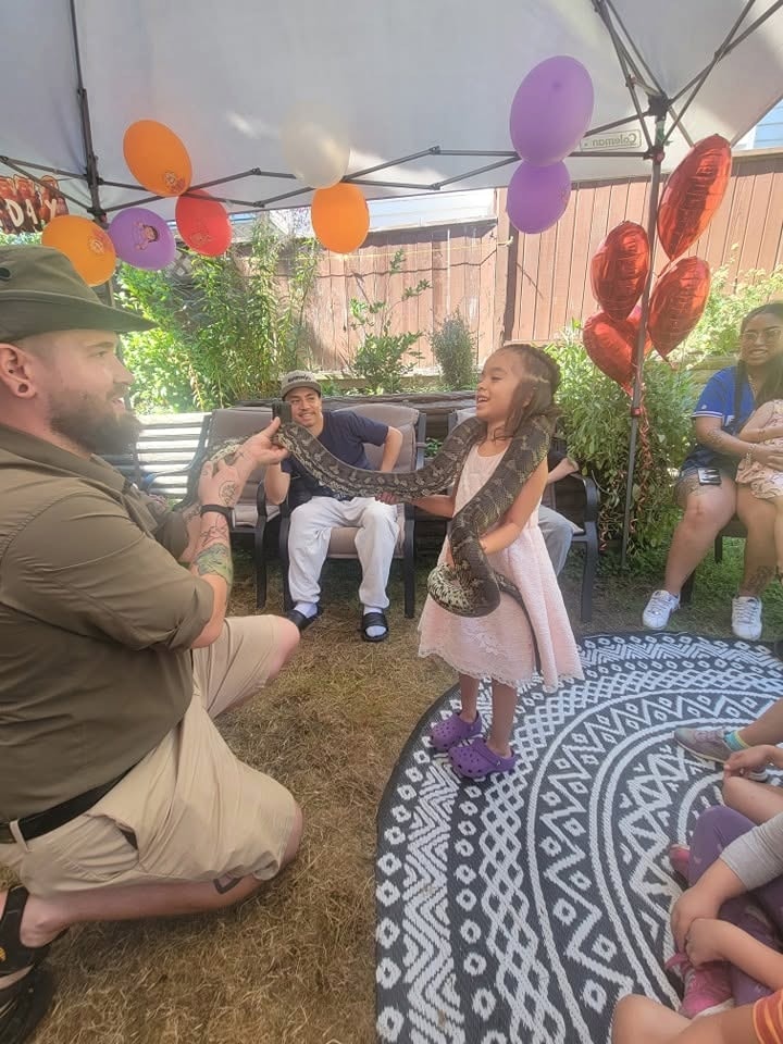 Kevin presenting to a child and audience